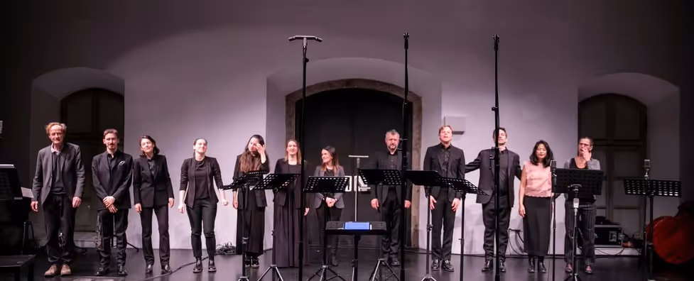 12 people take a bow on stage